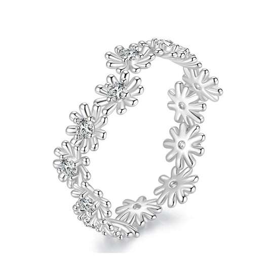 Silver floral ring with small diamonds on a white background